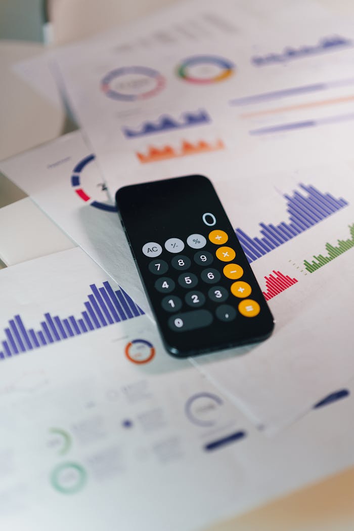 Calculator on graphs showing financial data and analytics. Ideal for business and finance themes.